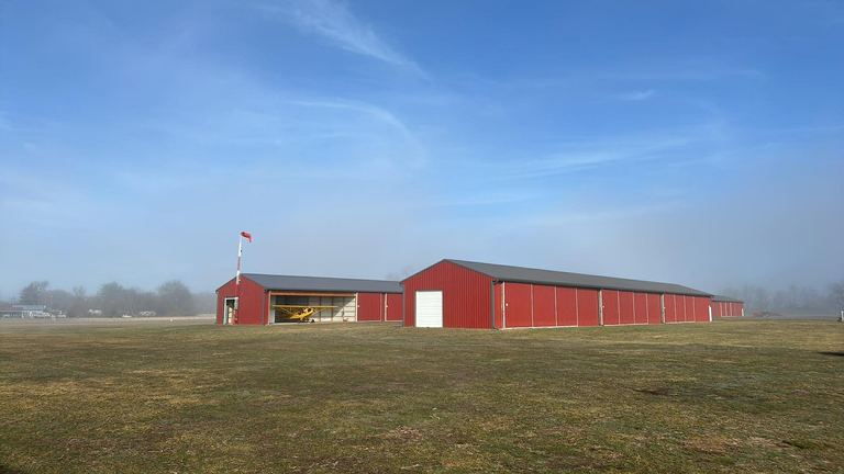 Bucks Airport hangars with Cub